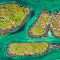 Aerial view of sporadically inhabited islands, Islets and skerries in a wide coastal plain. Husvaer, Helgeland Archipelago, Norway. July.