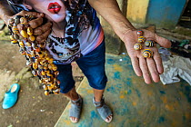 Illegal sale of jewelry made with Cuban tree snail (Polymita picta) shells near Yumury, Cuba. Highly commended in the Photojournalism category of the Wildlife Photographer of the Year competition 2021...
