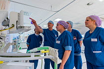 Anesthesia nurse is instructing recovery nurses about the new ventilators in place to take care of ICU patints after their recovery unit is converted to a new ICU unit. These recovery and anesthesia...