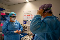Preparing to enter the Corona unit of the ICU. Putting on PPE and checking each other with a "buddy check" Jeroen Bosch Ziekenhuis, Den Bosch, &#39;s Hertogenbosch, The Netherlands March 2020. EDITO...