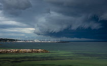 Storm clouds above Sandringham yacht club (in Por Philip Bay).? Sandringham, Victoria, Australia. ?May 2020.