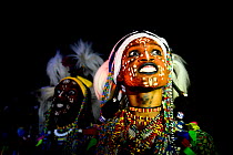 Two men from Wodaabe ethnic group dancing and singing with painted faces during Gerewol celebration, a gathering of different clans in which women choose a husband. Chad, Sahel, Africa. 2019.