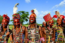 Men from Wodaabe nomadic tribe celebrating Gerewol, a gathering of different clans in which women choose a husband. Men dress in best clothes and ornaments to sing and dance in front of the young wome...