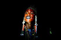 Man from Wodaabe ethnic group,head portrait at night. During Gerewol gathering of different clans women choose a husband. Men dress in best clothes and ornaments and sing and parade in front of the yo...