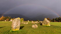 Rainbow and dark skies above Castlerigg Stone Circle, Lake District National Park, Cumbria, UK. November 2016.