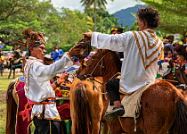 Traditionally dressed Bajau horsemen, also known as the Cowboys of the East, get ready to display their riding skills on colourfully dressed Bajau horses, during the Tamu Besar (Big Market) Festival,...