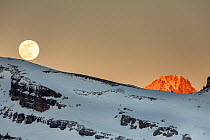 Moonrise over a mountain landscape in the evening. Leukerbad, Wallis, Valais, Switzerland, March