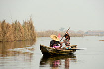 Two Tofinou women in boat on Lake Nokoue, Oueme River. Ganvie, known as African Venice, Benin, 2020.