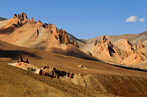 Zanskar mountains, erosion on mountainside with peaks beyond. Near Sisir La mountain pass, at an altitude of 4720m. Ladakh, India. September 2011.