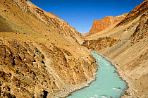 Tsarap River with pale blue water from glacial melt, and surrounding valley. Zanskar, Ladakh, India. September 2011.