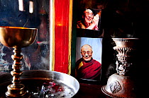 Lamps and photo of Dalai Lama in Karsha Gompa, a Buddhist monastery founded in the 10th Century. At altitude of 3650m. Padum Valley, Zanskar, Ladakh, India. 2011.