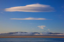 Lenticular clouds above Wrangel Island, Siberian Arctic, Chukchi Sea, Russia. August 2009.