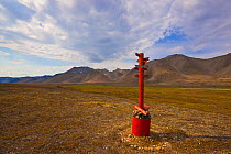 Marker designating the location where the Arctic Circle intersects the 180th meridian in the Siberian tundra of the Chukotka Autonomous Okrug. Chukotka, Siberia, Russia.