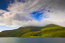 Nemo Peak, a stratovolcano and Black Lake (Lake Chyornoye), a crescent-shaped crater lake, on uninhabited Onekotan Island in the Kuril Islands, Russia.