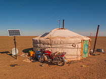 Nomadic Ger / yurt camp with modern motorbike and solar panel. Gobi Desert. Mongolia.