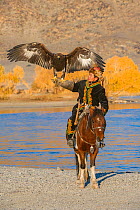 Young Kazakh Golden Eagle Hunter with his Eagle. Western Mongolia.