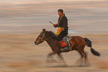 Mongolian on horse back at the Eagle Hunters festival near Ulgii, Western Mongolia.