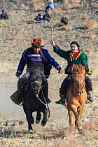 Male-female horse race, at the Eagle Hunters festival near Ulgii, Western Mongolia. Medium repro only