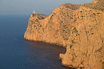 Cliffs with Cap de Formentor lighthouse on headland. Mallorca, Spain. August 2019.