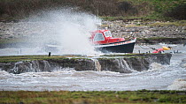 Small boats tossed in their moorings by Storm Jorge as it batters Clevedon harbour, Severn Estuary near Bristol, UK. March 2020.