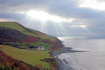 View from coastal footpath approaching Aberystwyth from the north, with moody sky, Wales, UK, December 2019.