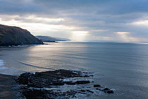View from coastal footpath approaching Aberystwyth from the north, with moody sky, Wales, UK, December 2019.