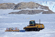 Tractor vehicle and Adelie penguin (Pygoscelis adeliae) colonies, Dumont d&#39;Urville station, Antarctica. December 2012