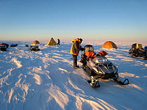 Nomadic field camp on the ice cap, packing the skidoos, Antarctica January 2007