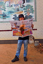 Photographer Deng with &#39;hot news&#39;, newspaper on fire, Zhang Jiang city, Guangdong province, China