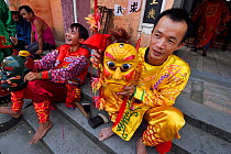 The traditional Nuo dance, or Lion Dance, performed during New Years festival, in the Song Zhu Toan village, Guangdong province, China
