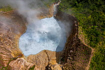 Aerial view of steam and gases rising from Boiling Lake, a water filled fumarole on active volcano. In cloud forest, Morne Trois Pitons National Park, Dominica, Lesser Antilles. 2020.