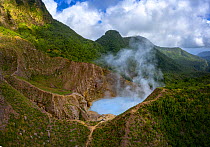 Steam and gases rising from Boiling Lake, a water filled fumarole on active volcano, surrounded by cloud forest. Morne Trois Pitons National Park, Dominica, Lesser Antilles. 2020.