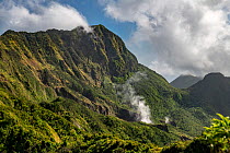 Steam rising from Boiling Lake, a sulphur lake surrounded by cloud forest on active volcano. Morne Trois Pitons National Park, Dominica, Lesser Antilles. 2020.
