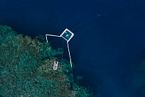Harrison Integrated Spawn Catcher Rearer Inflatable Pool over Great Barrier Reef, aerial view. Coral spawn caught with arms during synchronised spawning event and held in pool. Larvae reared alongside...