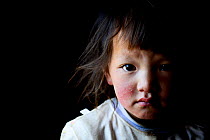 Child on Buddhist pilgrimage, portrait. Ganden Thubchen Choekhorling Monastery. Litang, Garze Tibetan Autonomous Prefecture, Sichuan, China. 2016.