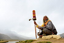 Man on Buddhist pilgrimage sitting in valley. Kham, Tibet. 2016.