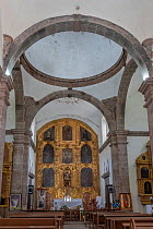 Altar with reredos on wall, pews in foreground. Mission San Francisco Javier. Near Loreto, Baja California Sur, Mexico. 2020.