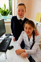Anastasia Puyko,a Nenets woman, who works as a nurse at the hospital in Yar-Sale. Her daughter, Elvira (behind) is studying banking. Yar-Sale, Yamal, NW Siberia, Russia. 2018.