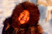 An Inuit girl, Sofie, warmly dressed in a fox fur hooded jacket (kapataq). N.W. Greenland. 1987