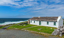 Traditional thatched cottage on coast. Brinlack, Bloody Foreland, County Donegal. Republic of Ireland. June 2020.