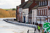 Flood defences alongside flooded River Severn, river overtopped the barriers. After Storm Ciara and Storm Dennis, the wettest February recorded in the UK. Bewdley, Worcestershire, England, UK. Februar...