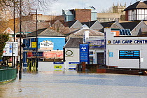 Flood waters from River Severn in road with garage and pub near town centre. After Storm Ciara and Storm Dennis, the wettest February recorded in the UK. Shrewsbury, Shropshire, England, UK. February...