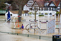 Man kayaking through flooded park inundated with water from River Severn, after Storm Ciara and Storm Dennis during the wettest February recorded in the UK. Shrewsbury, Shropshire, England, UK. Februa...