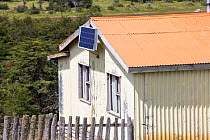 Photovoltaic panel on side of house. Near Puerto Natales, Magallanes, Chile. January 2020.