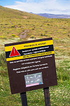 Puma (Puma concolor) warning sign on footpath in Torres del Paine National Park, Patagonia, Chile. January 2020.