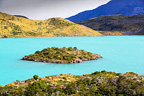 Island in Lake Pehoe, water coloured turquoise by glacial rock flour. Torres del Paine National Park, Patagonia, Chile. January 2020.