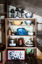 Radio, kitchen crockery and colanders on shelf in Wordie House, a former British scientific research base. Winter Island, Argentine Islands, Antarctica. 2020.