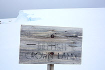 Fading wooden sign reading &#39;British Crown Land&#39; outside Wordie House, a former British scientific research base. Winter Island, Argentine Islands, Antarctica. January 2020.