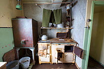 Trousers drying above kitchen stove, as left when researchers were evacuated in 1959. Station W, former British scientific research station, Detaille Island, Graham Land, Antarctica. 2020.