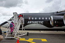 Tourists boarding plane during Antarctic tourism trip from Punta Arenas, Chile. South Shetland Islands, Antarctica. December 2019.